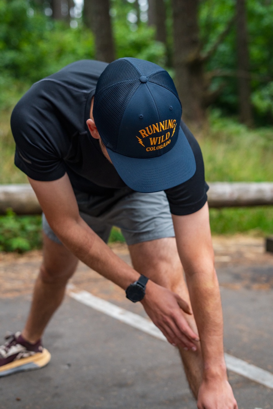 Runner stretching in a Running Wild trucker