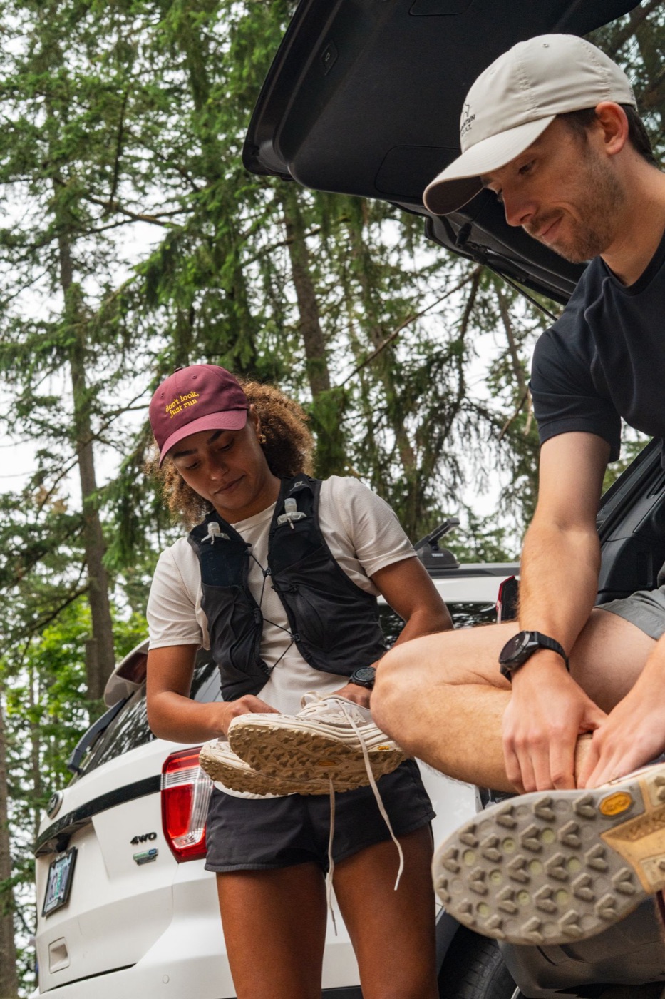 Runners changing into trail shoes at the car